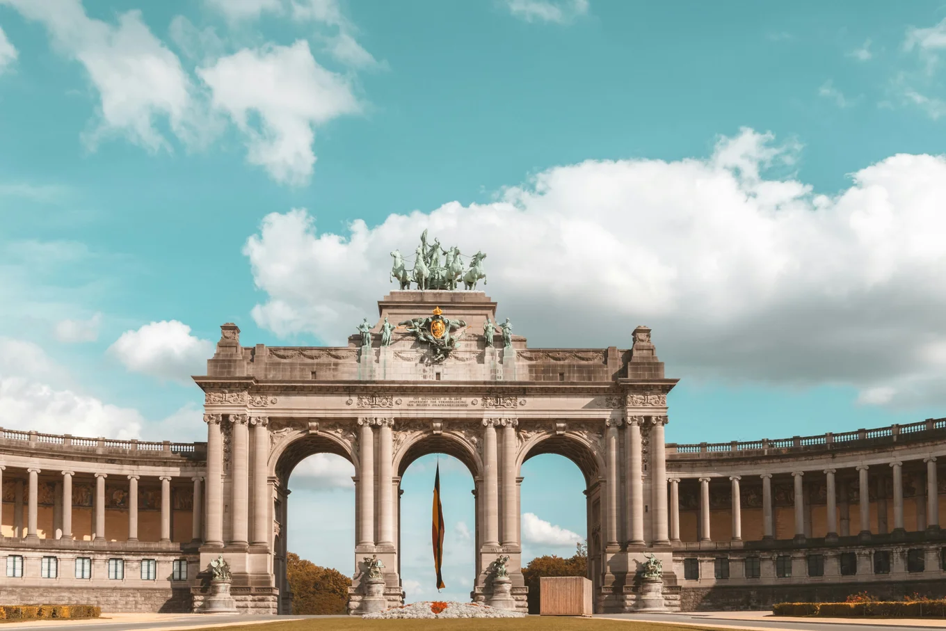 Brussels' Cinquantenaire Arch against a blue sky.