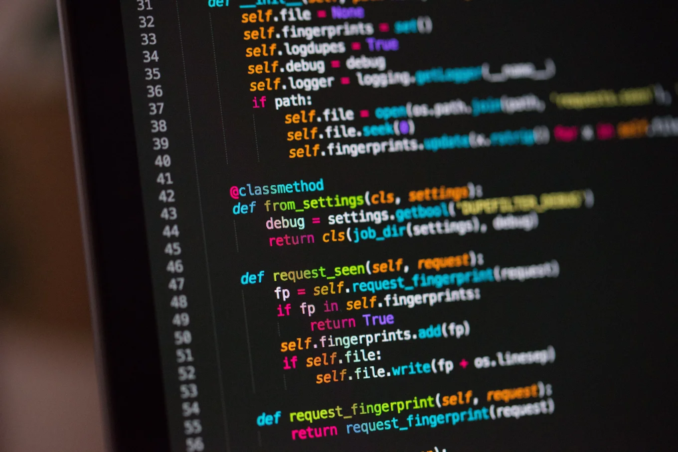 Colorful text code on a black computer screen.